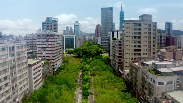 Aerial flyover famous greened Renai avenue (仁愛路)with trees and traffic in Taipei city, Taiwan - Skyl