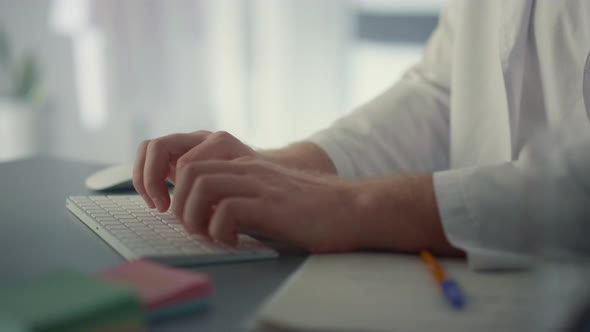 Physician Hands Typing Keyboard in Hospital Close Up