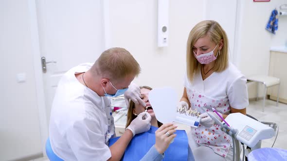 Woman having visit at the dentist. Female patient having her teeth examined by specialist