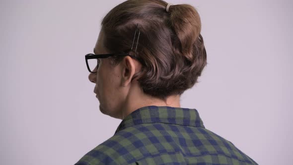 Rear View Head Shot of Hipster Man Looking Back and Removing Eyeglasses