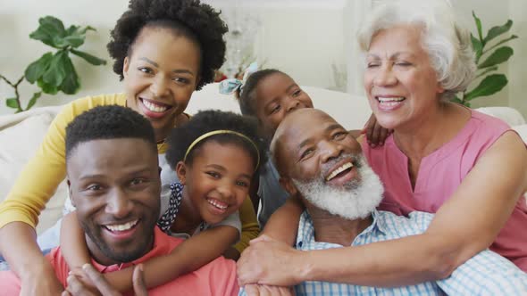 Portrait of happy african american family embracing in living room