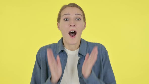 Young Woman Feeling Surprised on Yellow Background