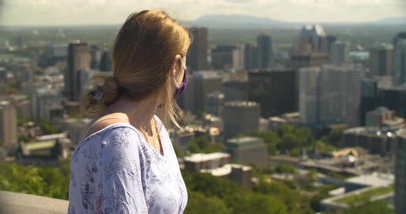 Woman Wearing Colored Mask Looking at City Scape