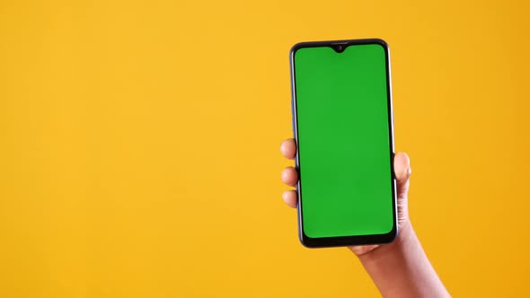 Close Up of Young Man Hand Using Smart Phone with Green Screen