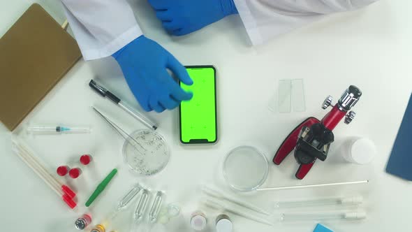 Doctor Working in Modern Laboratory Using Smartphone