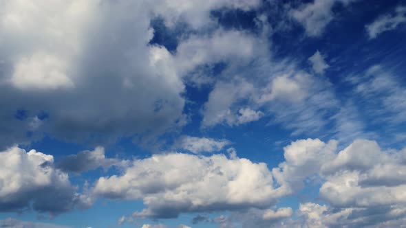 Timlamps Running Fluffy White Clouds in the Blue Sky