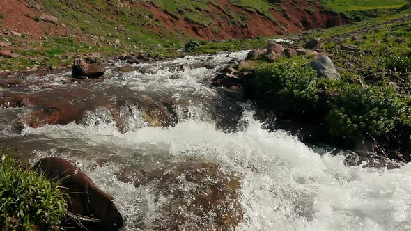 Glacial Mountain River Flows Down The Slope 10