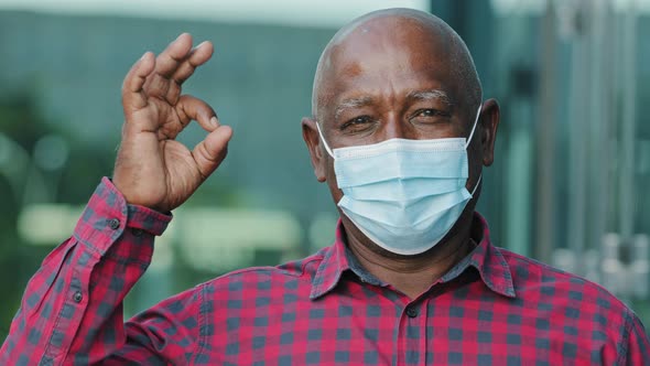 Closeup Portrait Elderly African American Man in Facemask Protect From Coronavirus Shows Ok Gesture