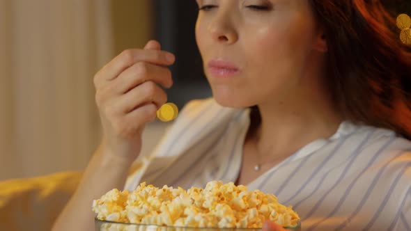 Pregnant Woman with Popcorn Watching Tv at Home