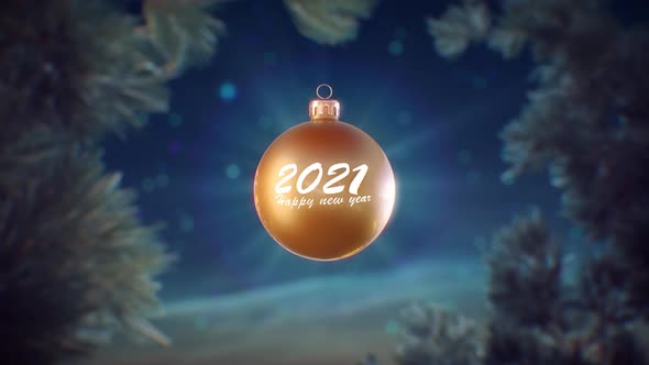 Gold christmas ball with 2021 happy new year text bokeh stars and sky background