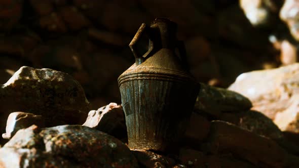 Old Metal Jug at Rocks alt