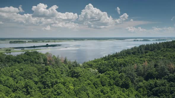 Green Forest Near Blue River or Lake Water in Suburb Wild Nature Landscape Area in Countryside