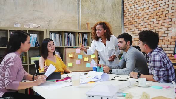 Asian woman leading business creative team