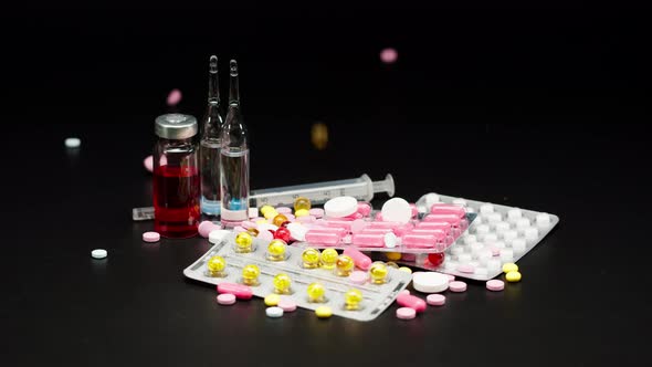 Closeup of Falling Coloured Medicine Tablets on Black Background Shooting of Fallen Red and Yellow