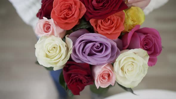 Overhead View of Beautiful Bright Rose Bouquet in Female Hands