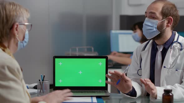 Elder Person Looking at Greenscreen on Laptop at Checkup Visit