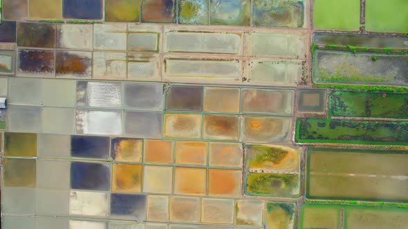 Aerial view flying over a beautiful colorful natural sea salt pond