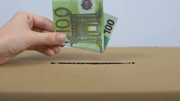 Female Hand Putting Euro Banknote in Donation Box