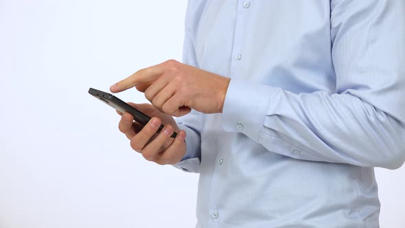 A Man Works on a Smartphone - Side Closeup - White Screen Studio