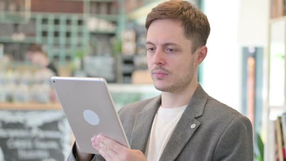 Portrait of Young Man Using Digital Tablet