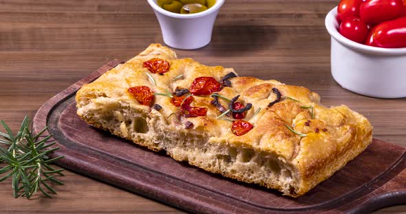 Traditional Italian Focaccia with pepperoni, cherry tomatoes, black olives, rosemary ando onion - ho