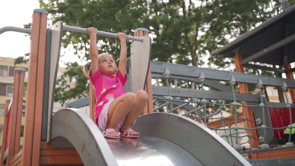 Child Playing on Playground Warm Summer Day