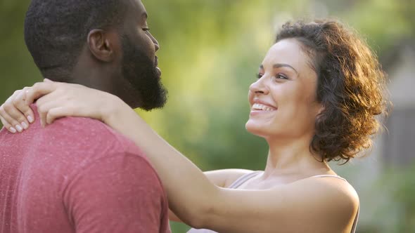 Positive and cheerful spouses embrace each other in warm and tender cuddles