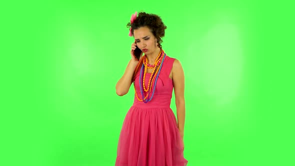 Girl Angrily Speaks on the Phone, Proves Something. Green Screen