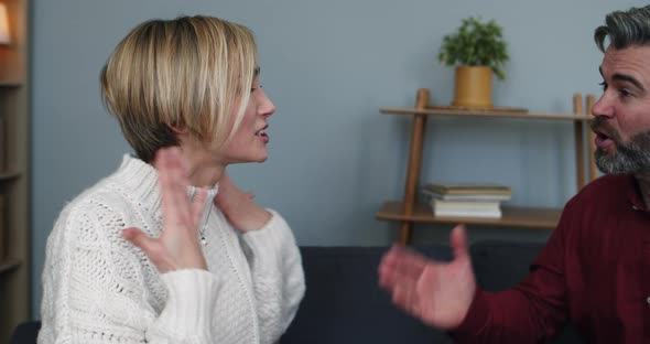 Close Up of Married Couple Shouting on Each Other While Sitting at Psychologist Office