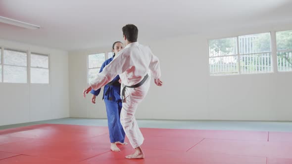 Judokas training by doing a randori on the judo mat