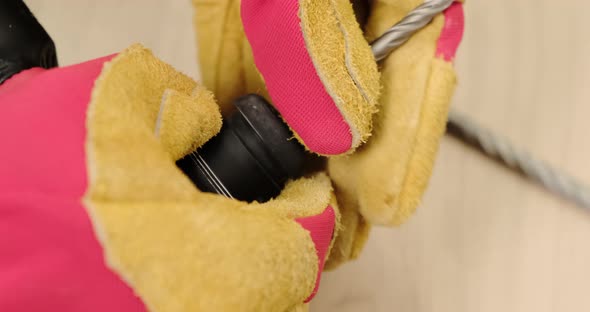 Man hand work with perforator in gloves. Close up.