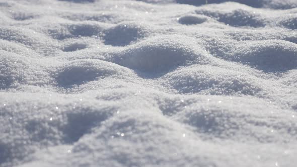 Dunes of milky white snow crystals close-up 4K 2160p 30fps UltraHD tilting footage - Sparkling  froz