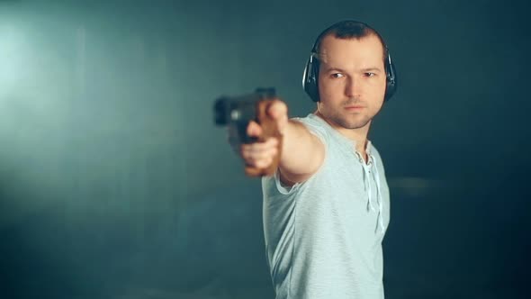 Man Shooting with Gun at a Target