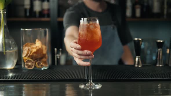 Woman Hands Toasting with Aperol Spritz Cocktails Woman in Bar Take Alcohol From Bartender