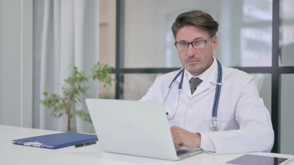 Doctor with Laptop Showing No Sign by Finger