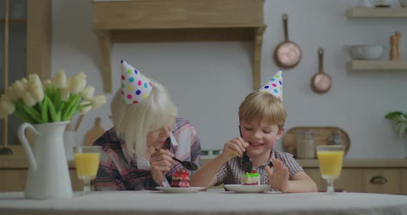 Preschool Kid in Party Hat Celebrates Birthday at Home. Family Eating Each Others Piece of Birthday
