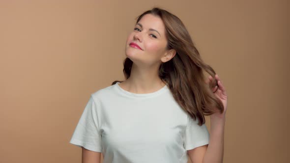 Monochrome Natural Makeup Look Caucasian Woman in Studio with Brunette Wavy Hair Blowing