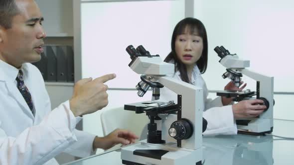 Scientists look into microscopes