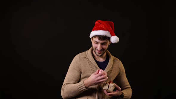 A man with a Santa hat catching gifts