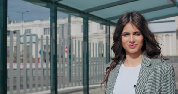 Attractive Brunette Girl Smiling and Walking Near Modern Office Building, Young Good Looking