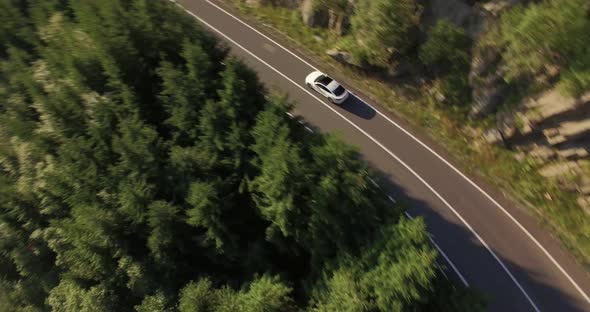 White car along alpine road