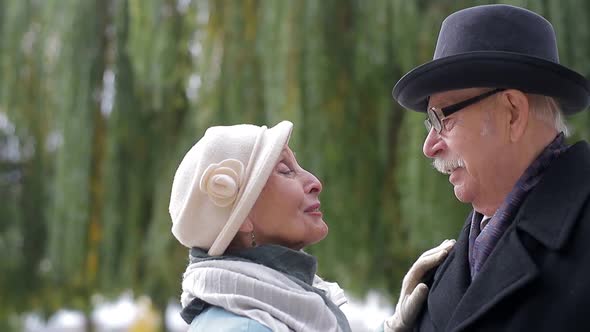 Sweet senior couple dancing in the park.