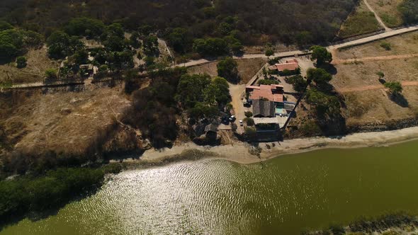 Aerial view of private residence near turbid river water, Brazil.