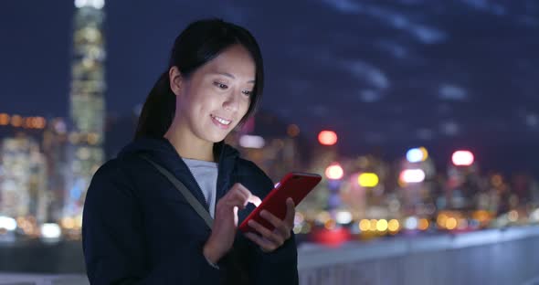 Woman Use of Mobile Phone in City at Night