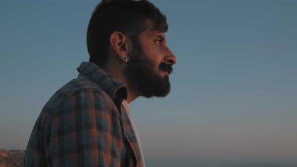 A middle eastern man looking at sunset