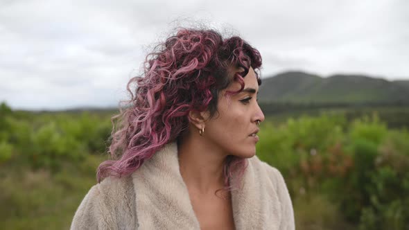 Portrait of Woman Looking Sideways with Wind Blowing Her Hair