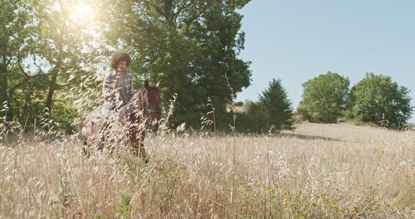 Man Riding Horses on a Sunny Outdoor Wild field.Friends Italian Trip in Umbria. Slow Motion