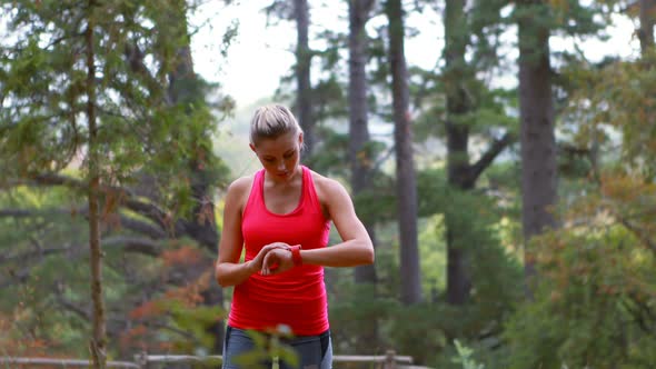 Woman adjusting a time on wristwatch