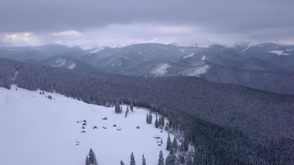 Flying Over Small Village in Carpathians Mountains