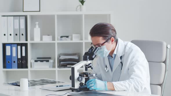 Professional medical doctor working in hospital office using computer technology.